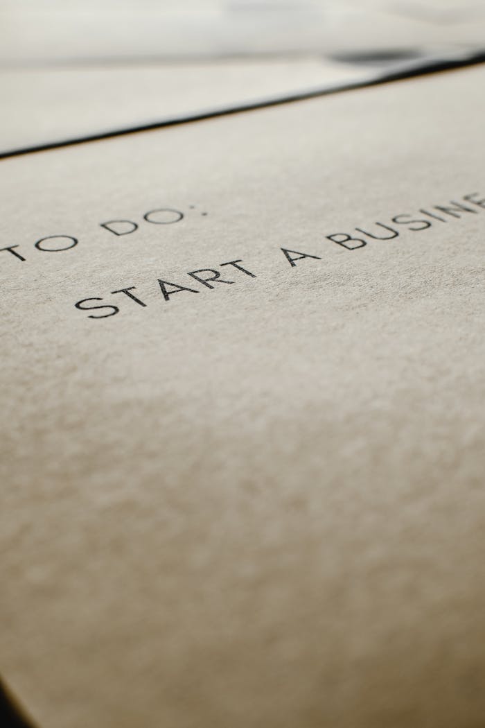 A focused image of a to-do list featuring 'Start a Business' on paper.